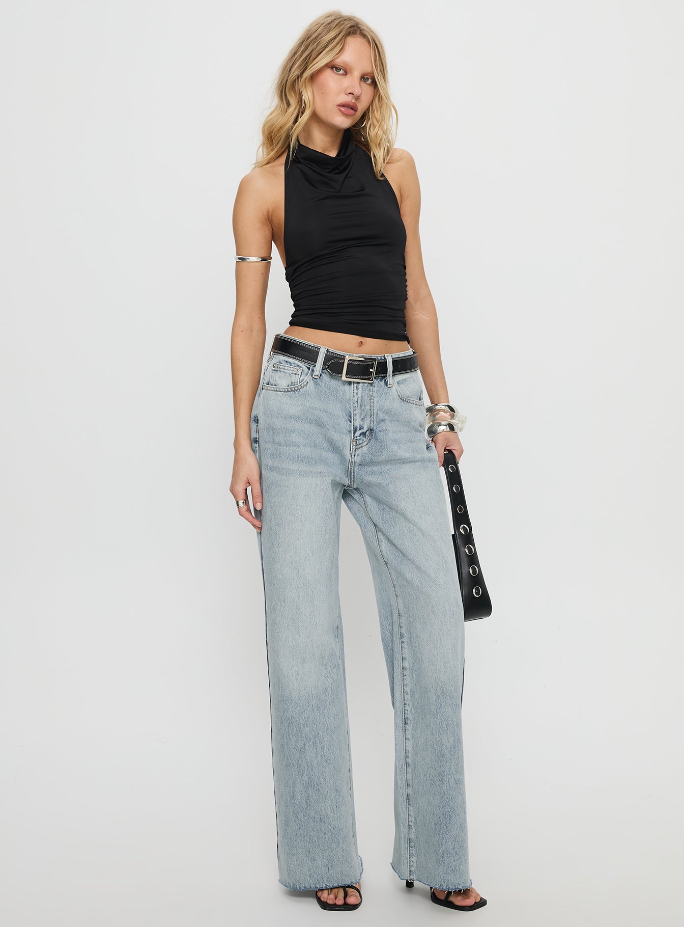 side view of model wearing Princess Polly Henesey High Rise Straight Leg Jeans Light Wash Mid Rise Jeans 