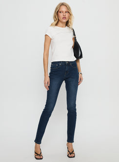 front view of model wearing Princess Polly Illyssa Mid Rise Skinny Jeans Mid Blue Wash Mid Rise Jeans 