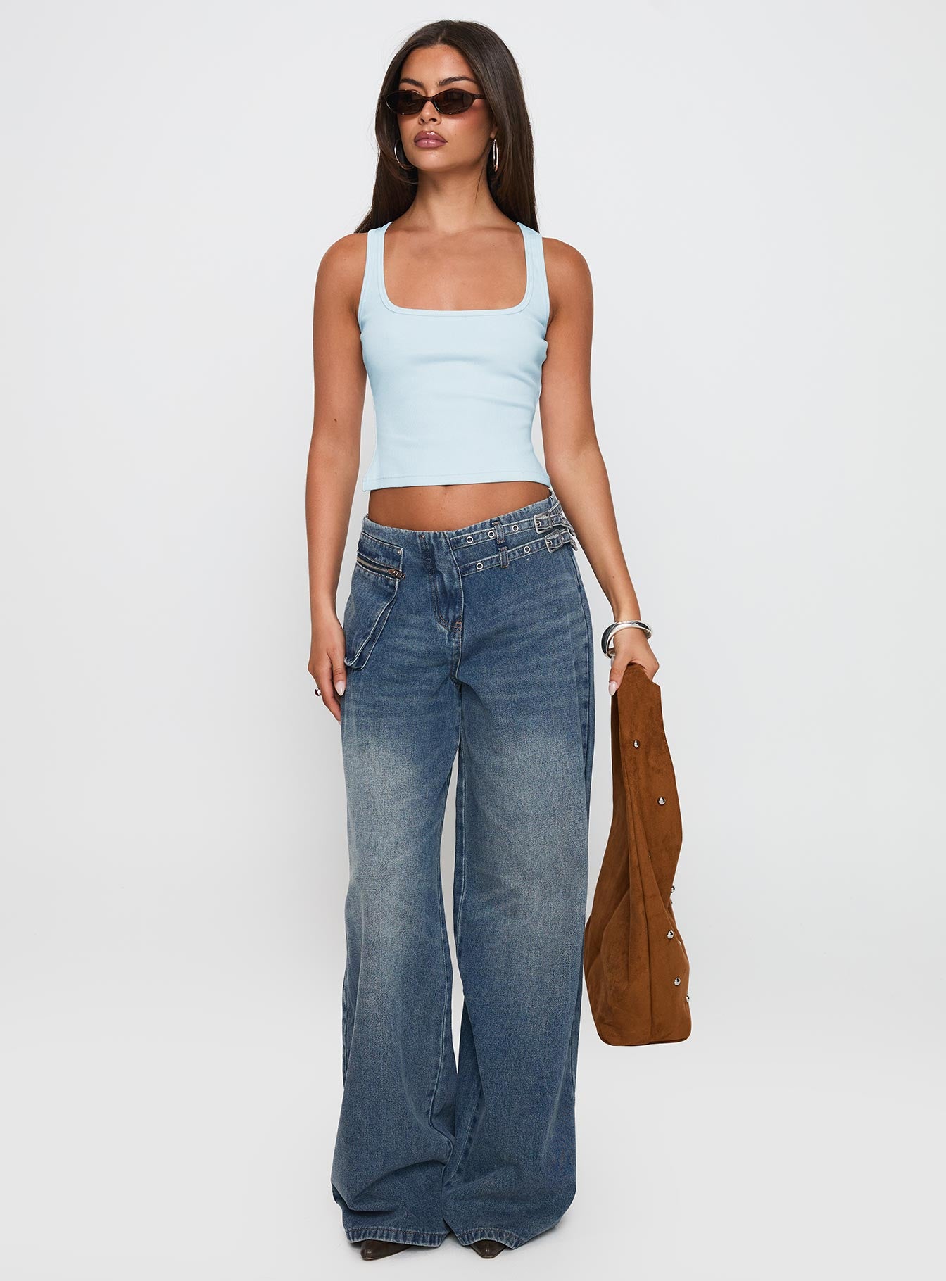 front view of model wearing Princess Polly Paltrow Mid Rise Wide Leg Cargo Jeans Mid Blue Wash Petite Mid Rise Jeans 