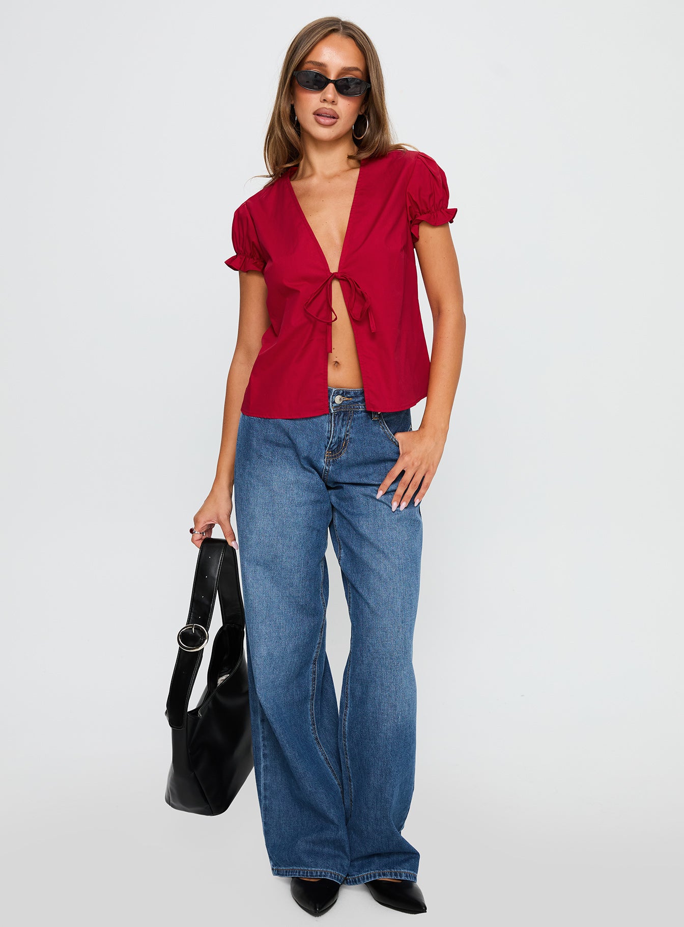 side view of model wearing Princess Polly Starstruck Tie Up Top Red Short Sleeves V-Neck 