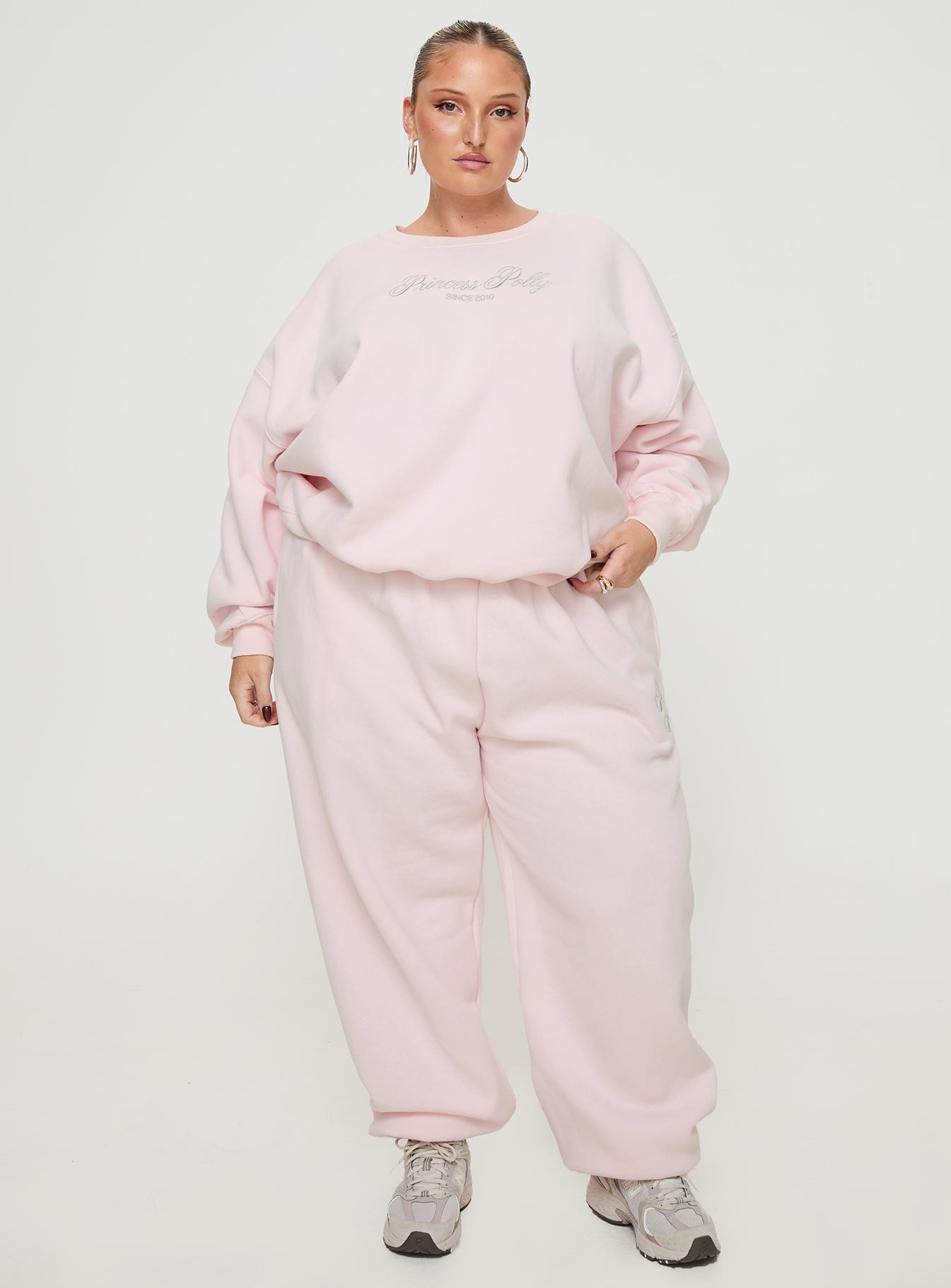 front view of model wearing Princess Polly Princess Polly Crew Neck Sweatshirt Script Baby Pink / Grey Curve 