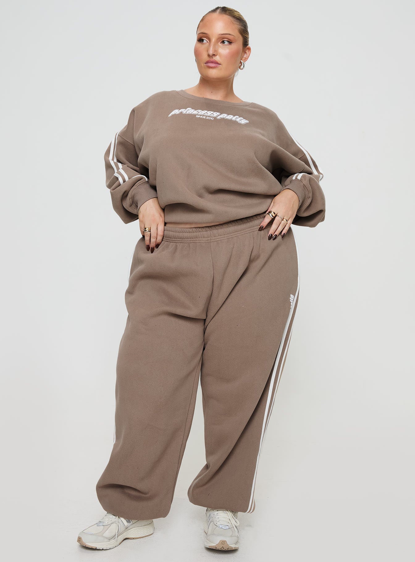 front view of model wearing Princess Polly Princess Polly Track Pants Stripe Taupe / White Curve 