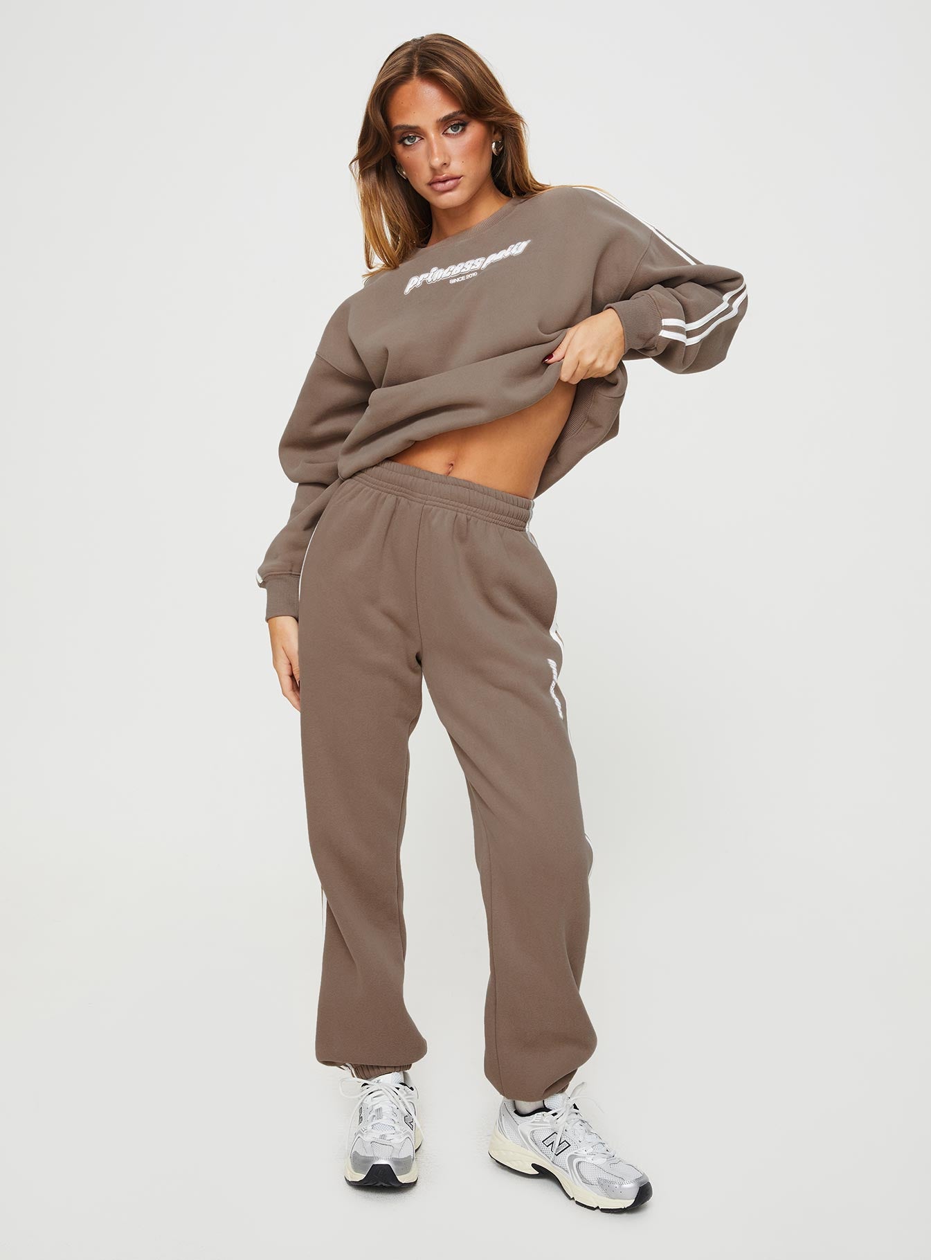 front view of model wearing Princess Polly Princess Polly Track Pants Stripe Taupe / White High Waisted Pants 