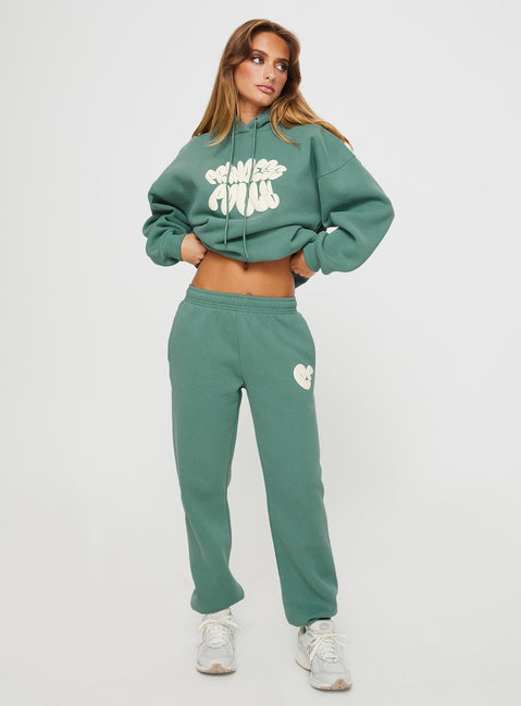 front view of model wearing Princess Polly Princess Polly Track Pants Bubble Text Sage / Eggshell Mid Rise 