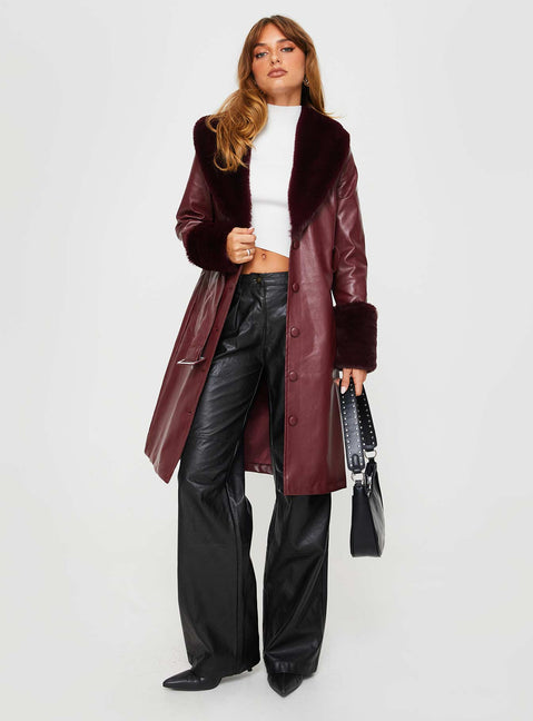 Longline coat Faux leather material, faux fur trimming, button front fastening, twin pockets at sides, removable waist belt