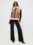 Shearling vest  Classic collar, twin hip pockets, shearling detail at shoulder and hem, faux leather detail and strap fastening at neck, silver-toned hardware, zip fastening at front 