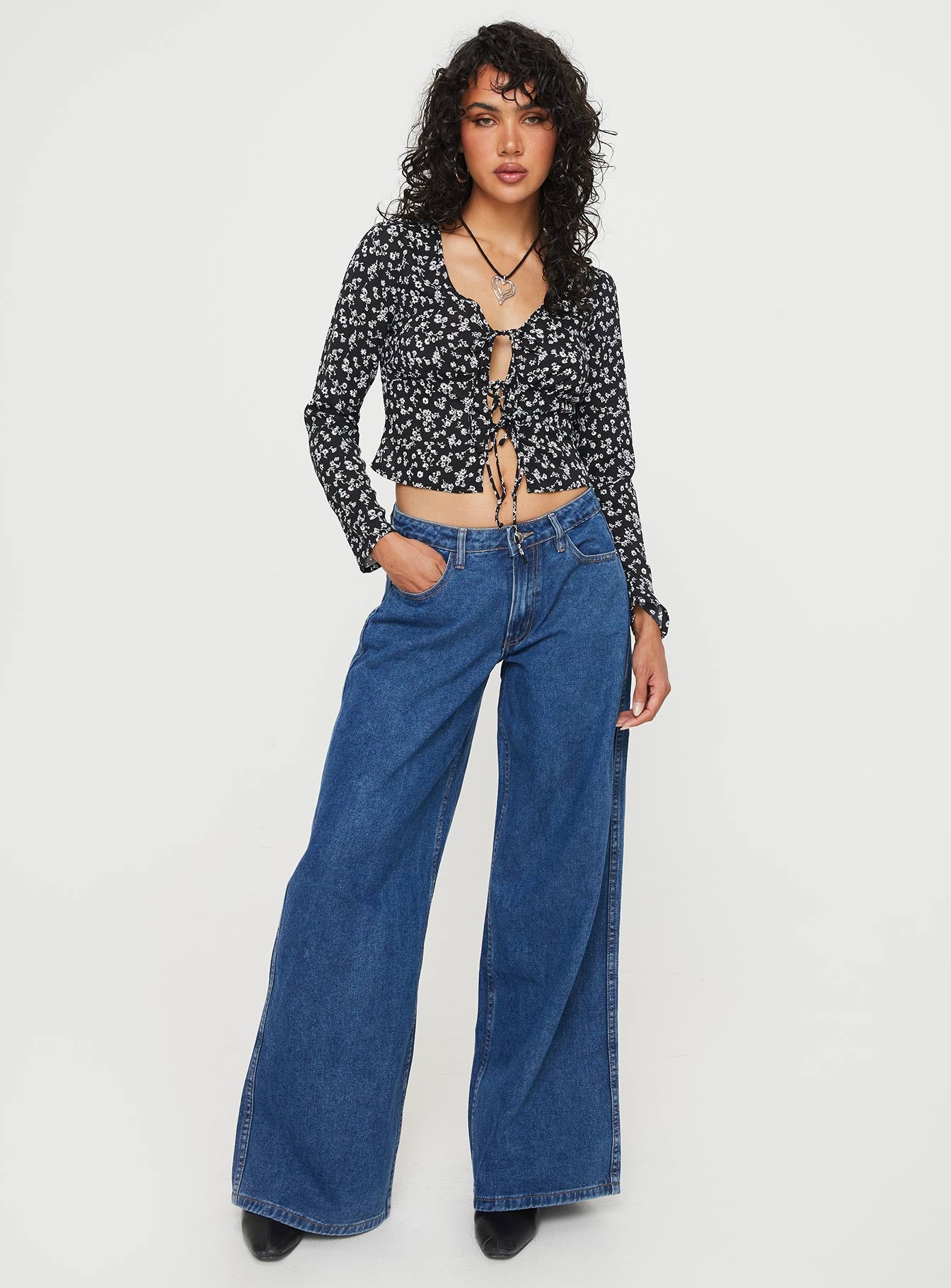 Front view of model wearing  front Princess Polly Full Sleeves Crew Neck  Mekki Long Sleeve Top Black Floral