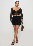   side view of model wearing Princess Polly Karley Low Waist Mini Skirt Black Curve Mini Skirts 