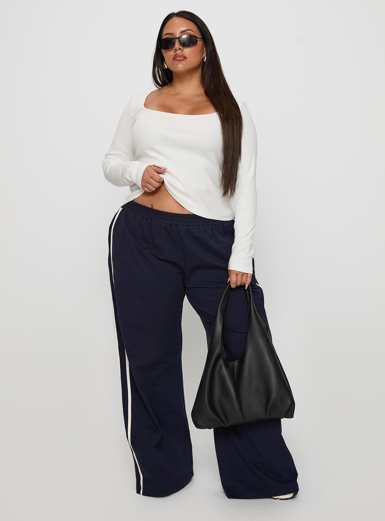 front view of model wearing Princess Polly Circuit Track Pants Navy Curve 