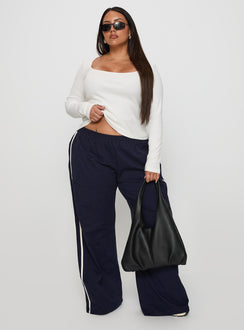 front view of model wearing Princess Polly Circuit Track Pants Navy Curve 