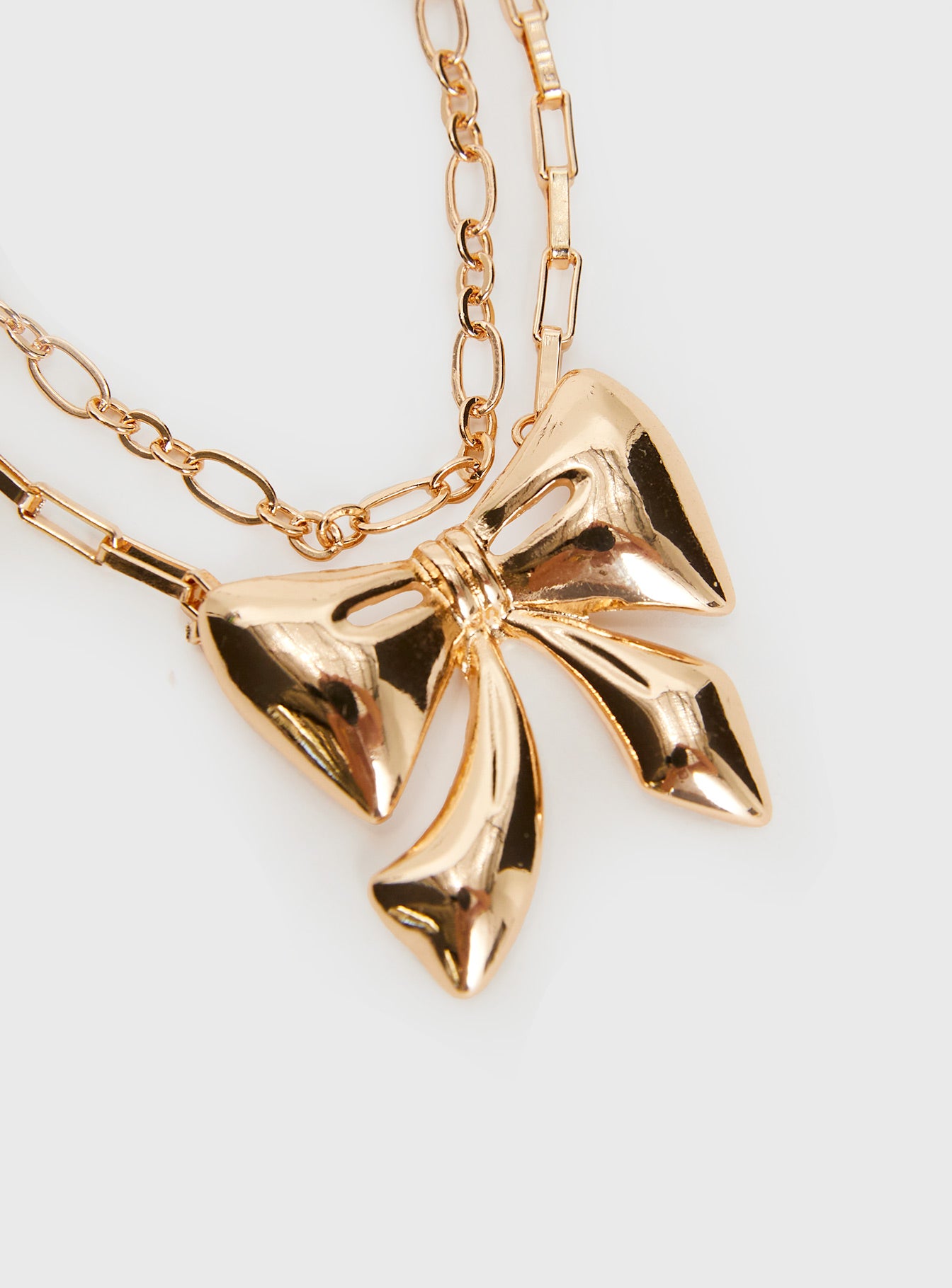 Gold-toned chain belt Two separate chains, large bow pendant, lobster clasp fastening Princess Polly Lower Impact