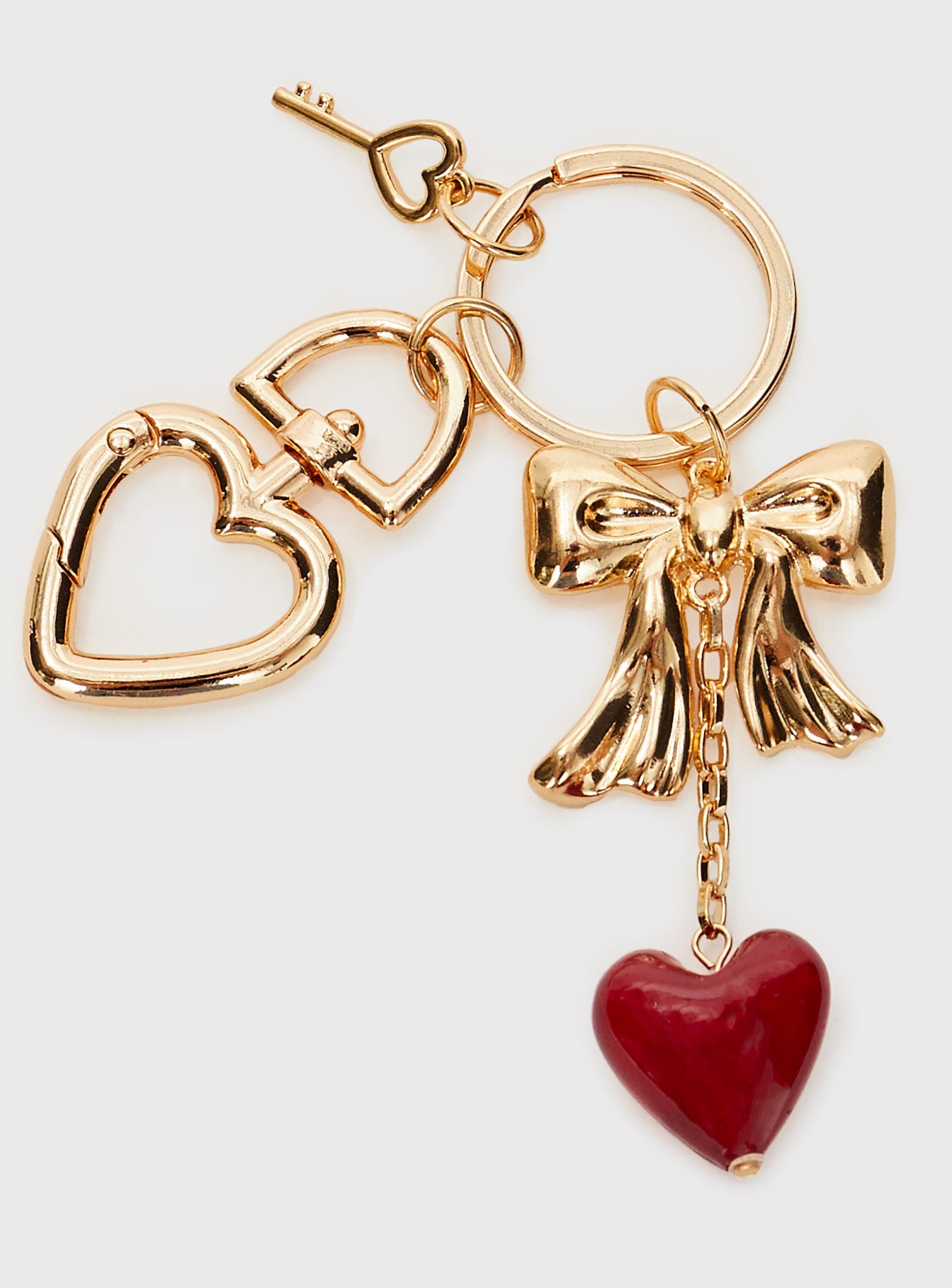 Gold toned keyring with three removable charms