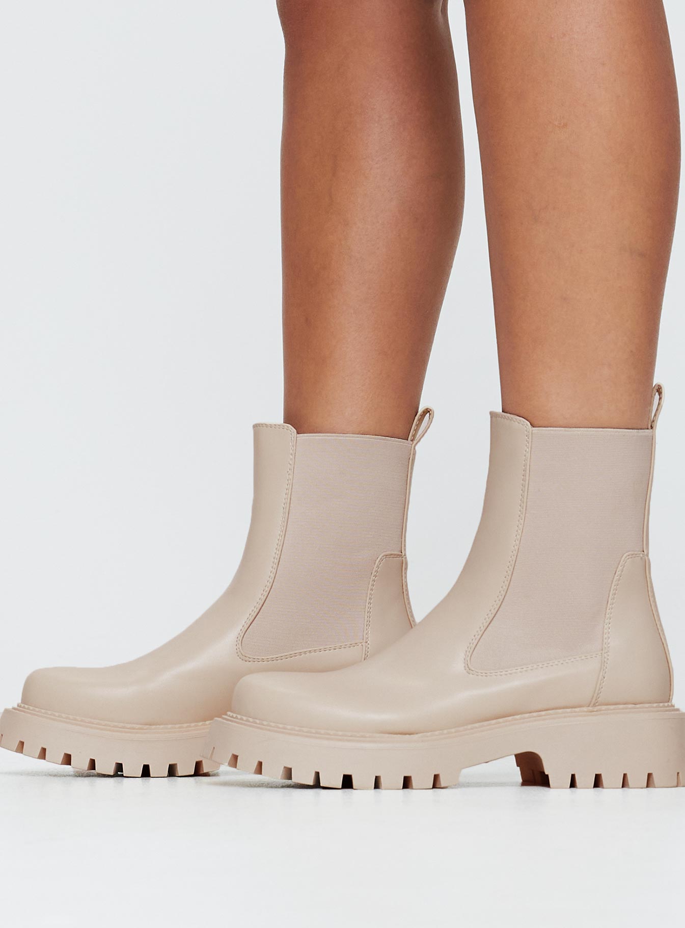 Faux leather boots Rounded toe, treaded sole, pull tab at back, passed footbed