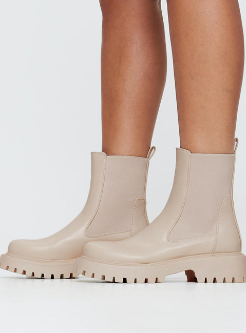 Faux leather boots Rounded toe, treaded sole, pull tab at back, passed footbed