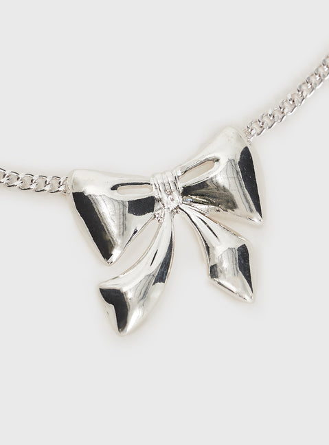 Silver-toned necklace Bow charm, lobster clasp fastening