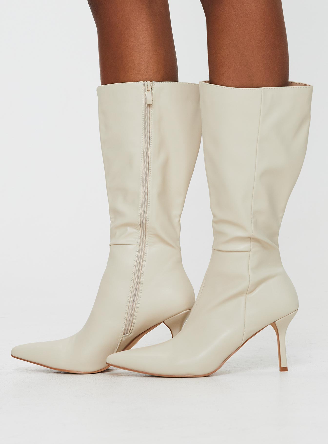 Cream Knee-high boots Faux leather material, zip fastening at inside, pointed toe, stiletto heel