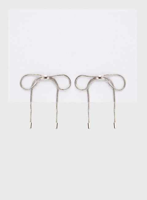 Silver-toned earrings Bow design, stud fastening
