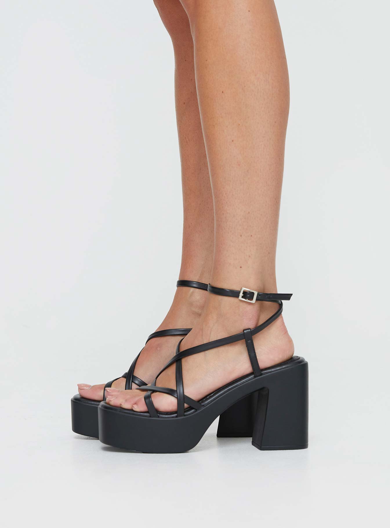 Heels Platform style, open toe, flared block heel Faux leather material, square open toe, thin upper straps Thin Ankle Strap with Adjustable Buckle Fastening