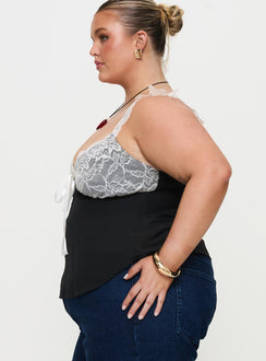 side view of model wearing Princess Polly Delvonte Top Black Curve Sleeveless Plunger 