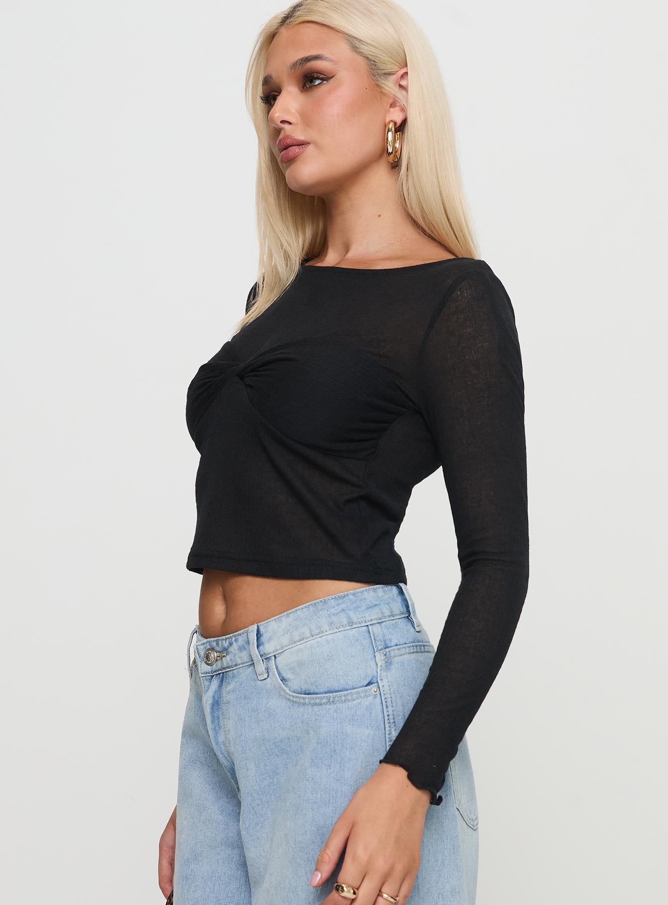 side view of model wearing Princess Polly November Long Sleeve Top Black Full Sleeves Boat Neck 