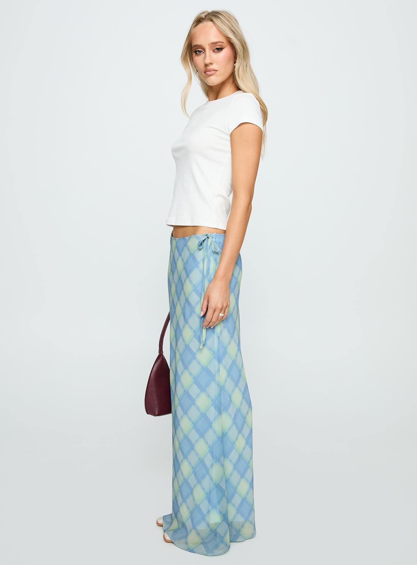   side view of model wearing Princess Polly Seafarer Tie Side Maxi Skirt Blue Check Maxi 