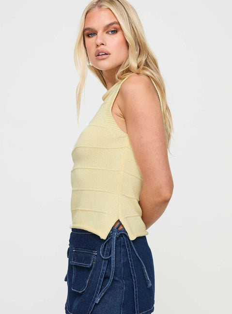 side view of model wearing Princess Polly Hisplane Knit Top Cream Sleeveless Crew Neck 