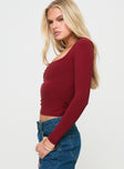 side view of model wearing Princess Polly Selenie Long Sleeve Top Red Full Sleeves Square Neck 