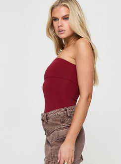 side view of model wearing Princess Polly Niner Strapless Bodysuit Burgundy Petite Sleeveless 