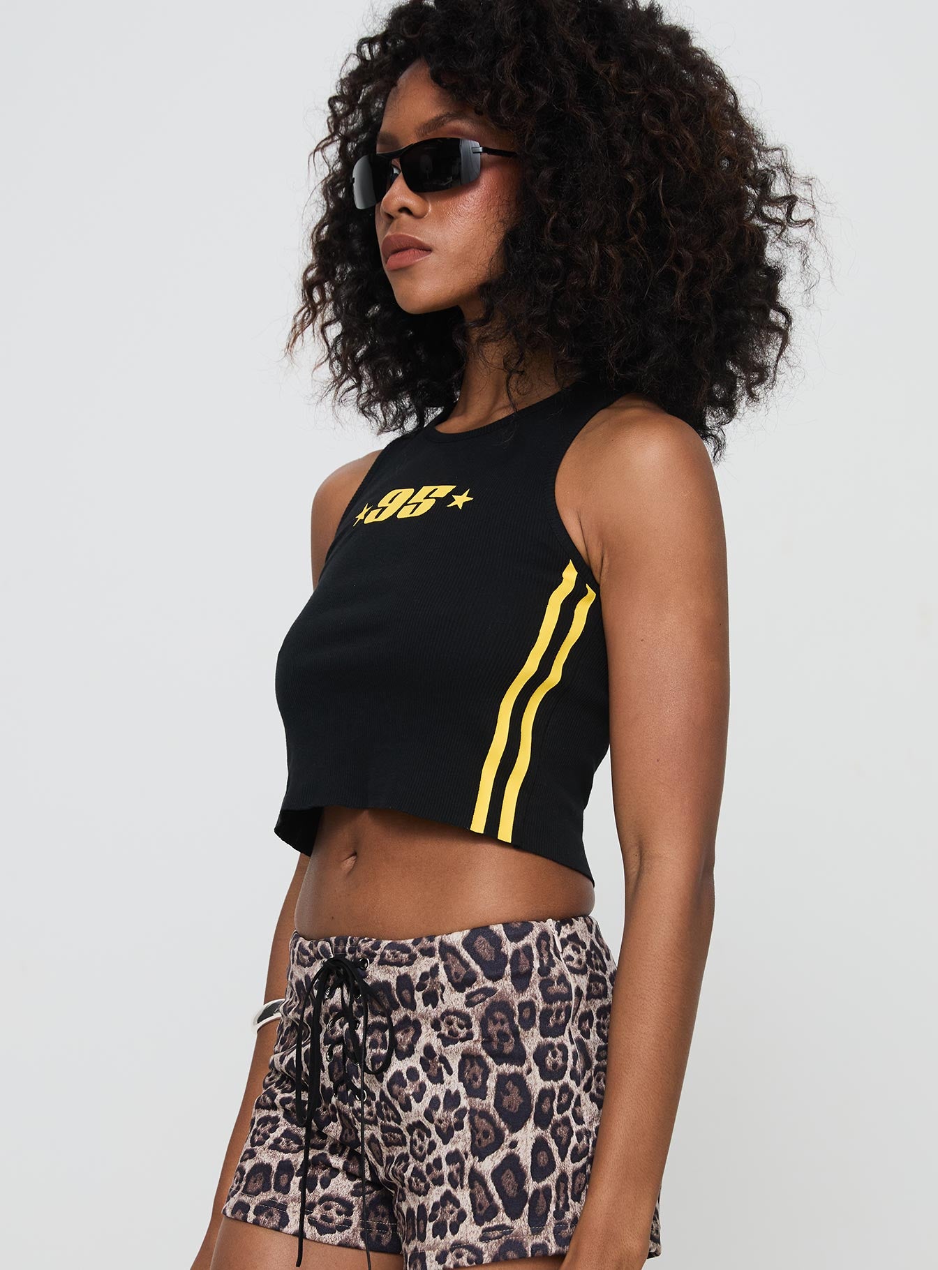 side view of model wearing Princess Polly Sports 95 Tank Black Sleeveless Crew Neck 