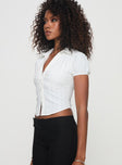 Shirt Classic collar, button fastening, puffed sleeves, ruched bust detail Non-stretch material, unlined 