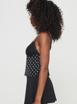 side view of model wearing Princess Polly Castien Top Black Polka Sleeveless Plunger 