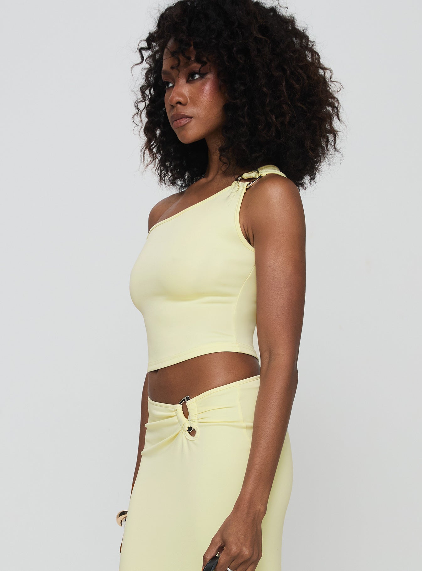 side view of model wearing Princess Polly Rios One Shoulder Top Cream Sleeveless Asymmetric Neckline 