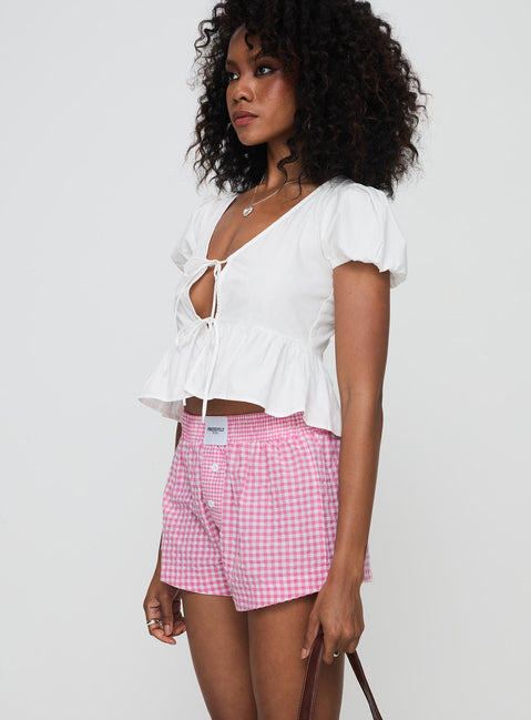 side view of model wearing Princess Polly Back To It Boxer Shorts Pink Gingham High Waisted Shorts 