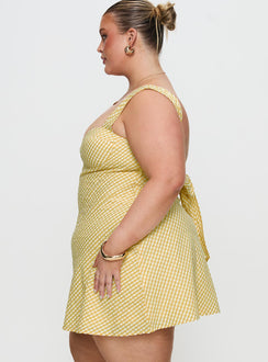 side view of model wearing Princess Polly Mcbeath Mini Dress Yellow Curve Sweetheart Neckline 