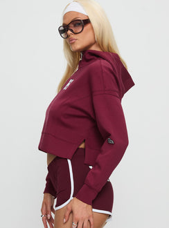 side view of model wearing Princess Polly Harvard Buttersport Half-zip Hoodie Crimson cropped 