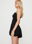 Strapless playsuit Shirred top, textured material, ruffle trim along neckline, V detail, layered ruffle hem  Good stretch, lined bottoms