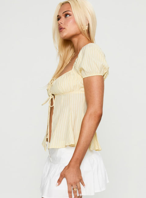 side view of model wearing Princess Polly How To Fly Tie Detail Top Yellow Short Sleeves Square Neck 