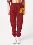 side view of model wearing Princess Polly USC Sweatpants Cardinal Red / White 