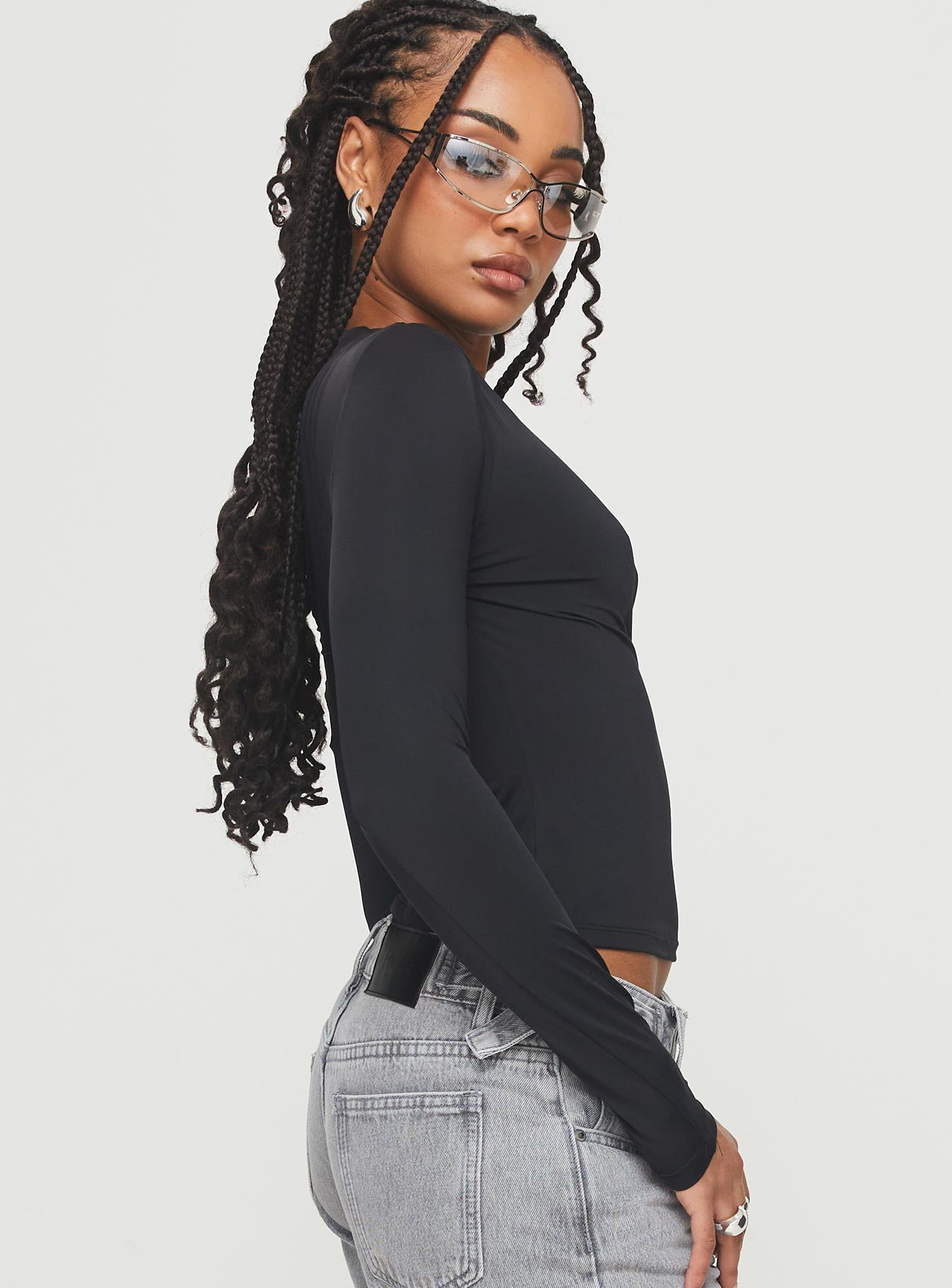 back view of model wearing Princess Polly Lasharie Long Sleeve Top Black Full Sleeves Asymmetric Neckline 