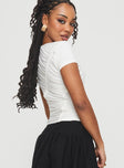 back view of model wearing Princess Polly Pettle Top White Short Sleeves Crew Neck 