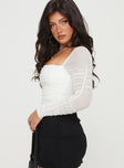 side view of model wearing Princess Polly Delany Bodysuit White Petite Full Sleeves Square Neck 