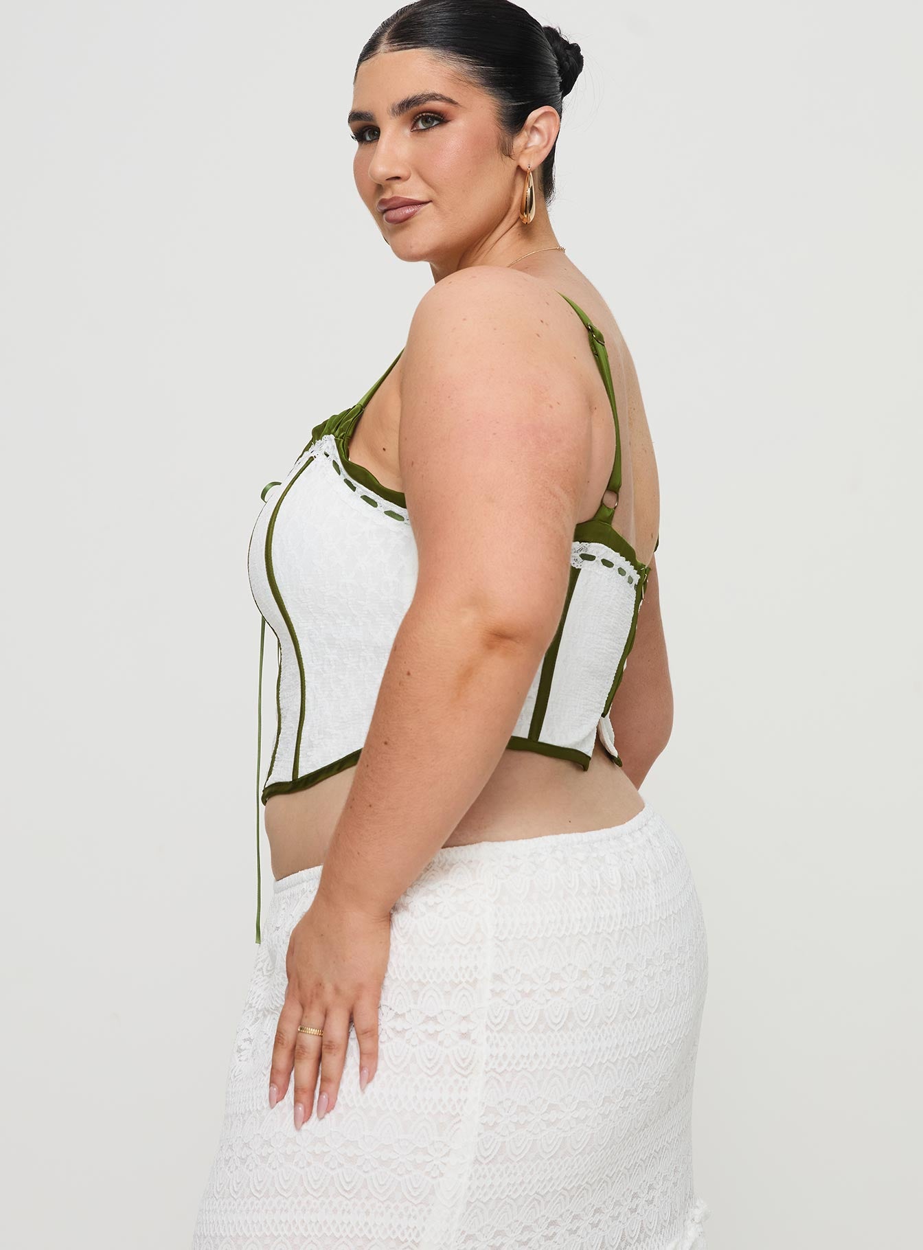 side view of model wearing Princess Polly Jiraia Lace Corset Top White / Green Curve Sleeveless Sweetheart 