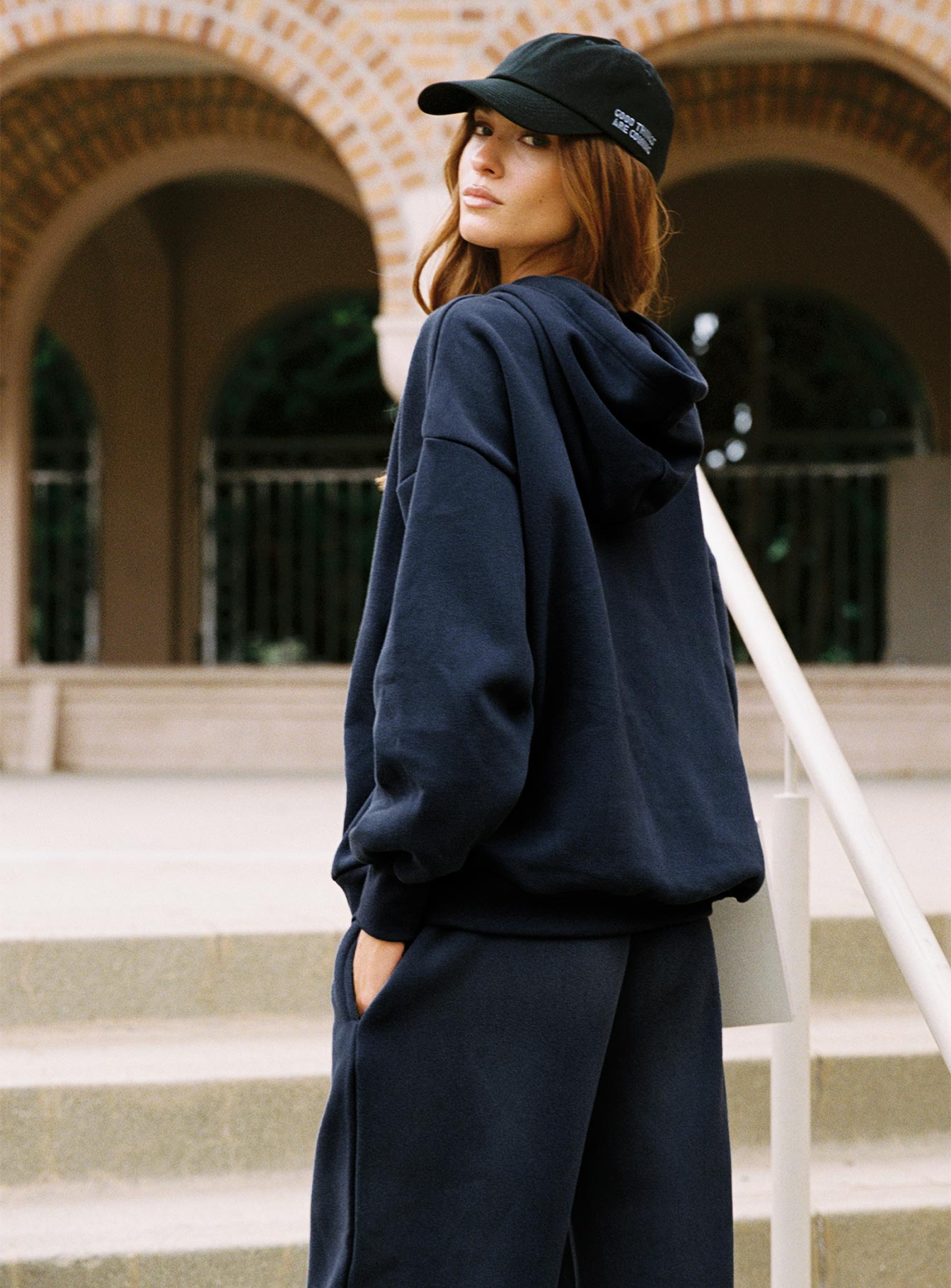side view of model wearing Princess Polly Dream Fleece Classic Hoodie Navy Longline Jumpers 