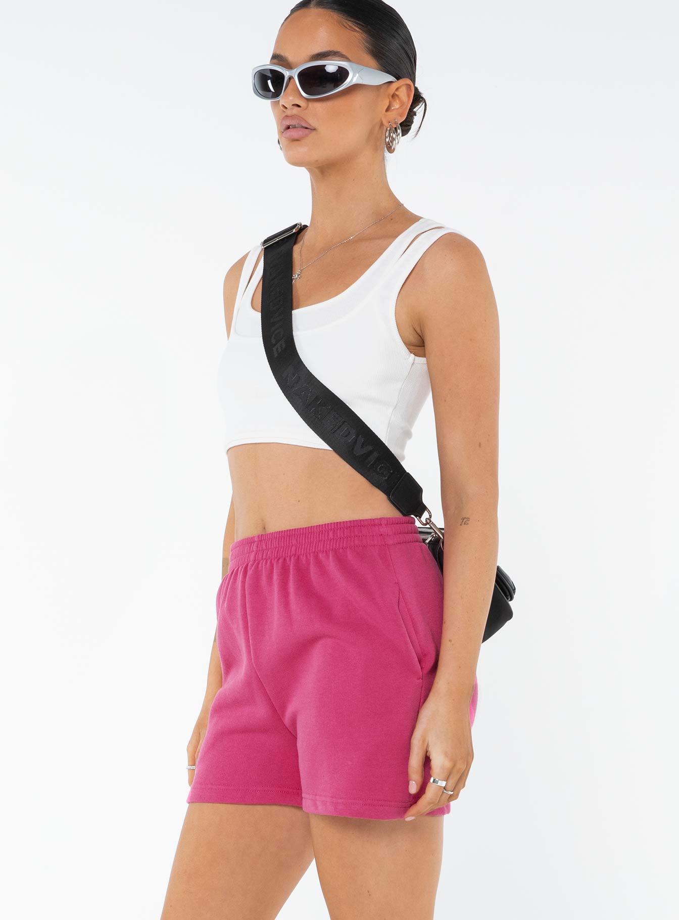 side view of model wearing Princess Polly Cenzo Track Shorts Pink High Waisted Shorts 