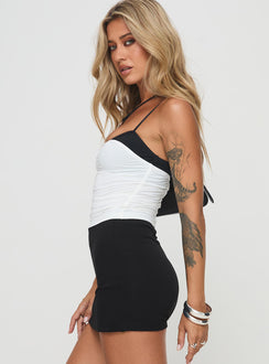 side view of model wearing Princess Polly Vickee Top White / Black Sleeveless Scoop Neck 