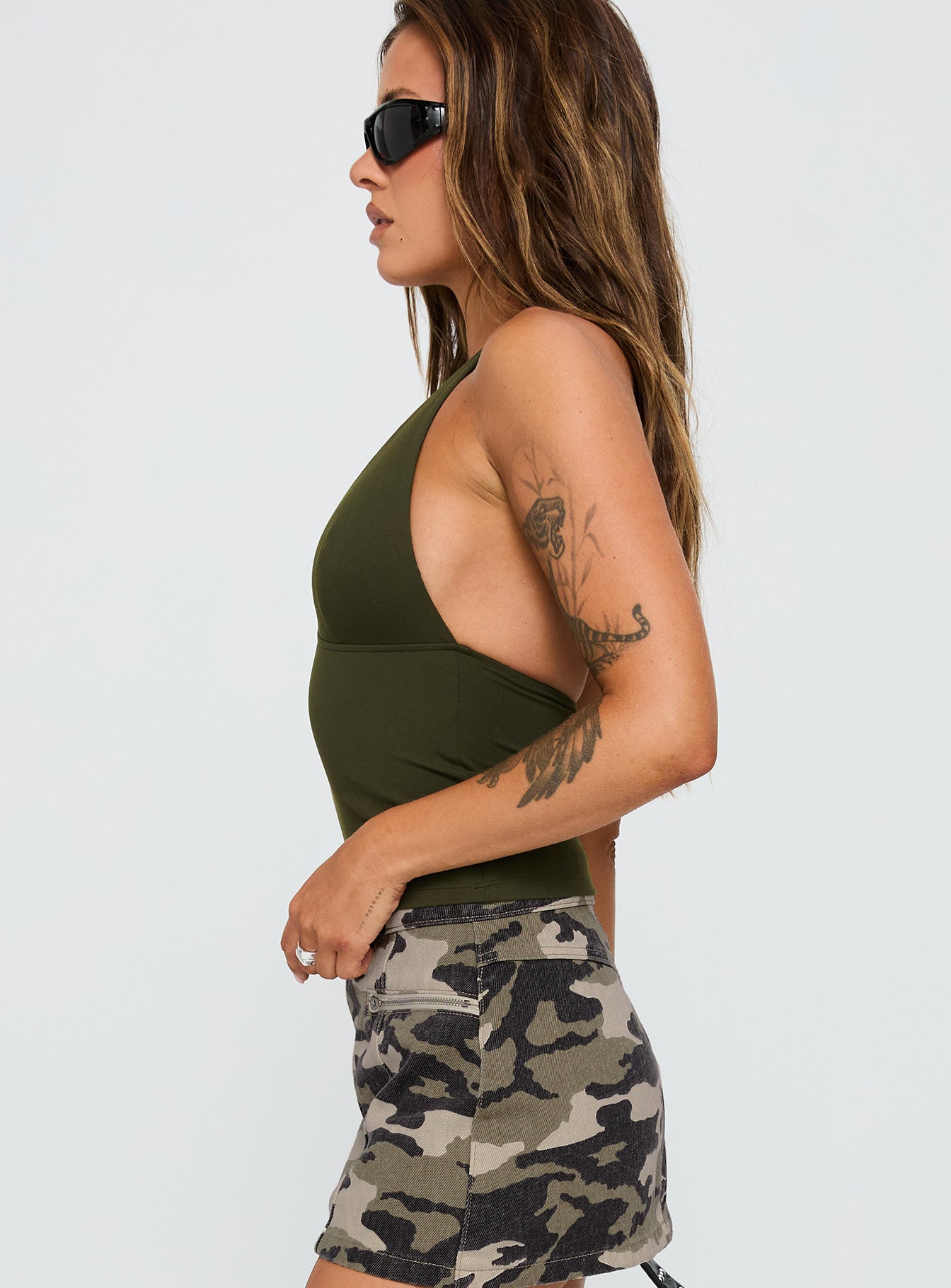 side view of model wearing Princess Polly Impress Me Halter Top Green Sleeveless Plunger 