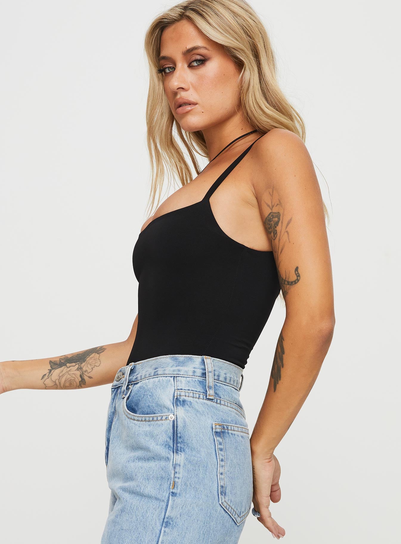 side view of model wearing Princess Polly Off Stage Bodysuit Black Sleeveless 