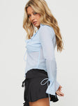 side view of model wearing Princess Polly Tomek Long Sleeve Top Blue Full Sleeves Plunger 