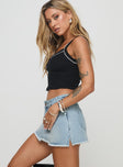 side view of model wearing Princess Polly Mitzo Mid Rise Denim Skort Light Wash High Waisted Shorts 