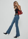 side view of model wearing Princess Polly Iker Flared Jeans Mid Wash Mid Rise 